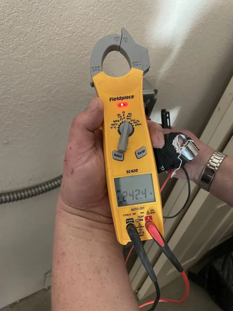 Voltage testing with clamp meter during Electrical Installation Services in Orrington